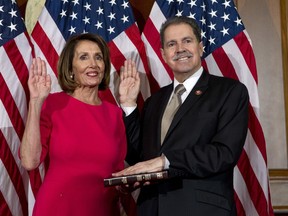 FILE - In this Jan. 3, 2019, file photo, House Speaker Nancy Pelosi of Calif., administers the House oath of office to Rep. Jose Serrano, D-N.Y., during a ceremonial swearing-in on Capitol Hill in Washington, during the opening session of the 116th Congress. Serrano, a 16-term Democrat from the South Bronx, says he has Parkinson's Disease and will retire at the end of his term.
