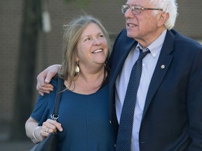 FILE - In this April 19, 2016, file photo, Democratic presidential candidate Sen. Bernie Sanders, I-Vt., and his wife Jane take a walk in State College, Pa. The Sanders Institute, a think tank founded by Democratic presidential contender Bernie Sanders' wife and son, has stopped accepting donations and plans to suspend all operations by the end of May.