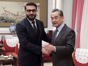 FILE - In this Jan. 10, 2019, file photo, Afghanistan national security adviser Hamdullah Mohib, left, shakes hands with Chinese Foreign Minister Wang Yi before proceeding to their meeting at the Zhongnanhai Leadership Compound in Beijing. Hamdullah Mohib is blasting U.S. talks with the Taliban, saying the Trump administration has alienated the Afghan government, legitimized the militant network and is crafting a deal that will never lead to peace.