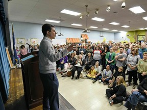 In this March 23, 2019, photo, South Bend Mayor Pete Buttigieg speaks to a crowd about his presidential run during the Democratic monthly breakfast at the Circle of Friends Community Center in Greenville, S.C. Buttigieg was the longest of long shots when he announced a presidential exploratory committee in January. But now the underdog bid is gaining momentum, and Buttigieg can feel it.