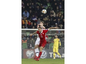 France's Benjamin Pavard left, fights for the ball with Moldova's Radu Ginsari right, during the Euro 2020 group H qualifying soccer match between Moldova and France at Zimbru stadium in Chisinau, Moldova, Friday, March 22, 2019.