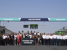 The drivers pose with members of the FIA for a group photo and tribute to Charlie Whiting, the former FIA Formula One Race Director, ahead of the Australian Formula 1 Grand Prix in Melbourne, Australia, Sunday, March 17, 2019.