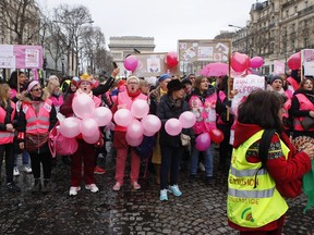 Women and yellow vest demonstrators march through Paris.