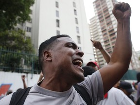 A supporter of President Nicolas Maduro screams at supporters of of Venezuela's self-proclaimed interim president Juan Guaido, during a rally in Caracas, Venezuela, Friday, March 29, 2019. The International Federation of Red Cross and Red Crescent Societies said Friday that it is poised to deliver aid to Venezuela, warning that it will not accept any interference from President Nicolas Maduro or opposition leader Juan Guaido.