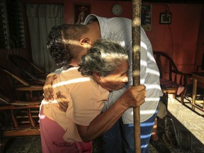 Martin Josue Paz embraces his grandmother Alba Aleman after he was released from prison and placed under house arrest, in Managua, Nicaragua, Friday, March 15, 2019. Nicaragua's government said it has released 50 opposition prisoners in an apparent bow to a demand by the opposition Civic Alliance for freeing of about 770 people considered political prisoners, as a condition for resuming political talks which had been suspended.