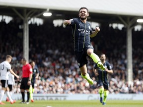 Manchester City's Bernardo Silva celebrates after scoring the opening goal during the English Premier League soccer match between Fulham and Manchester City at Craven Cottage stadium in London, Saturday, March 30, 2019.