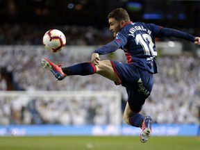 Huesca's Javier Galan reaches for the ball during a Spanish La Liga soccer match between Real Madrid and Huesca at the Santiago Bernabeu stadium in Madrid, Sunday, March 31, 2019.