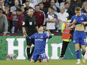 Everton's Bernard kneels down celebrating after scoring his side's second goal during the English Premier League soccer match between West Ham United and Everton at London Stadium in London, Saturday, March 30, 2019.