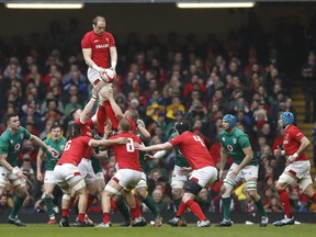 Wales captain Alun Wyn Jones, passes down the ball in a line out during the Six Nations international rugby union match between Wales and Ireland at the Millennium stadium in Cardiff, Wales, Saturday, March 16, 2019.