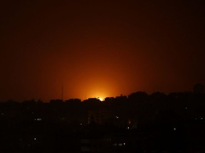 An explosion caused by Israeli airstrikes is seen on Gaza City, early Friday, March 15, 2019. Israeli warplanes attacked militant targets in the southern Gaza Strip early Friday in response to a rare rocket attack on the Israeli city of Tel Aviv, as the sides appeared to be hurtling toward a new round of violence.