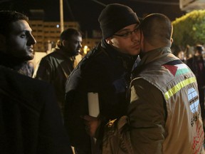 CORRECTION: IT IS THE UMRA, OR MINOR PILGRIMAGE, NOT THE HAJJ - A Palestinian Muslim pilgrim hugs a relative before leaving for the umrah, or minor pilgrimage, to the holy city of Mecca, while waiting for a bus en route to Rafah border between Gaza Strip and Egypt, in Gaza City, Saturday, March 2, 2019. Gazan residents resumed the umrah pilgrimage, that can be undertaken at any time of the year, after nearly five years of an Egyptian ban.