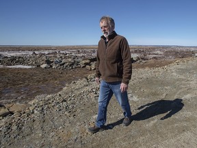 John Atkinson, an area farmer and land owner, stands on a dike along the LaPlanche River near Amherst, N.S. on Wednesday, March 20, 2019. The area is at risk of being overwhelmed by rising waters that could sweep over the aging dike and turn Nova Scotia into a virtual Island. The event could occur at any time through an increasingly probable combination of weather conditions, say emergency officials and geographers watching the area.