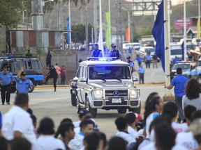 Nicaragua's President Daniel Ortega drives his Mercedes Benz SUV to the inauguration ceremony of a highway overpass in Managua, Nicaragua, Thursday, March 21, 2019. Ortega's government and opposition began negotiating Thursday how to carry out the release of hundreds of political prisoners arrested in the past year of unrest, after the government announced Wednesday it would free the prisoners within 90 days in exchange for the lifting of external sanctions.