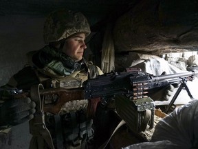 FILE - In this Wednesday, Nov. 28, 2018 file photo, a Ukrainian soldier takes his position near frontline with Russia-backed separatists in Shyrokyne, eastern Ukraine. Five years into Ukraine's conflict with Russia, Moscow seems to have Ukraine pinned against the ropes. Ukraine's ambition of joining the EU and NATO is indefinitely stalled, it has no realistic way to reclaim control of Russian-annexed Crimea, or to end the war with Russia-backed separatists in the east. It's no wonder a comedian is leading in the polls for the presidential election on Sunday, March 31, 2019.