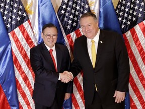 Philippine Foreign Affairs Secretary Teodoro Locsin Jr., left, and U.S. Secretary of State Mike Pompeo shake hands prior to their bilateral meeting in suburban Pasay city, southeast of Manila, Philippines Friday, March 1, 2019. Pompeo is in the Philippines for talks on the two countries' relations as well as the mutual defense treaty.