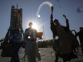 An Orthodox priest conducts a blessing service in front of the Soyuz FG rocket at the Russian leased Baikonur cosmodrome, Kazakhstan, Thursday, March 14, 2019. The new Soyuz mission to the International Space Station (ISS) is scheduled on Thursday, March 14 with U.S. astronauts Christina Hammock Koch, Nick Hague, and Russian cosmonaut Alexey Ovchinin.