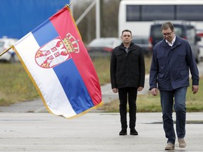 In this Nov. 17, 2017, photo, Serbia's President Aleksandar Vucic, right, reviews an honor guard with his Defense Minister Aleksandar Vulin during a bilateral Serbian and U.S. airborne exercise at Lisicji jarak airport, some 15 kilometers (10 miles) north of Belgrade, Serbia. A U.S. envoy urged Serbia and Kosovo on Friday, March 8, 2019 to stop mutual provocations and resume dialogue amid rising tensions between the two wartime foes.
