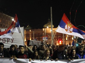 People march during a protest in Belgrade, Serbia, Saturday, March 16, 2019. Thousands of people have rallied in Serbia's capital for 15th week in a row against populist President Aleksandar Vucic and his government.