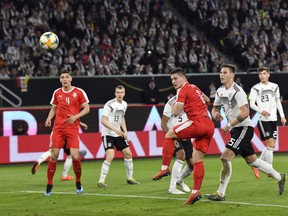 Serbia's Luka Jovic, third right, scores his side's opening goal during a international friendly soccer match between Germany and Serbia at the Volkswagen Arena stadium in Wolfsburg, Germany, Wednesday, March 20, 2019.