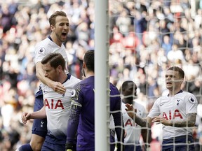 Tottenham players celebrate after Arsenal's Pierre-Emerick Aubameyang missing a penalty during the English Premier League soccer match between Tottenham Hotspur and Arsenal at Wembley stadium in London, Saturday, March 2, 2019.