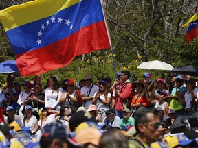 Anti-government protesters start to gather for a rally to demand the resignation of Venezuelan President Nicolas Maduro in Caracas, Venezuela, Monday, March 4, 2019. The United States and about 50 other countries recognize opposition Congress President Juan Guaido as the rightful president of Venezuela, while Maduro says he is the target of a U.S.-backed coup plot.