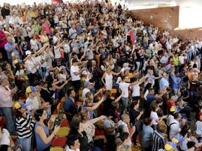 Supporters of the National Assembly President Juan Guaido, cheer for him during a meeting with residents in the Hatillo municipality of Caracas, Venezuela, Thursday, March 14, 2019. Guaido has declared himself interim president and demands new elections, arguing that President Nicolas Maduro's re-election last year was invalid.