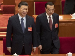 Chinese President Xi Jinping and Chinese Premier Li Keqiang arrive for the closing session of the National People's Congress in Beijing's Great hall of the People on Friday, March 15, 2019.