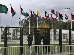 Security forces stand guard outside the conference center where Arab leaders will hold the 30th Arab League Summit which opens Sunday, in Tunis, Tunisia, Wednesday, March 27, 2019.
