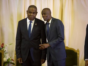 FILE - In this Sept. 17, 2018 file photo, Prime Minister Jean-Henry Ceant, left, and Haiti's President Jovenel Moise, attend the minister's ratification's ceremony at the national palace in Port-au-Prince, Haiti. An American security contractor at the center of a mysterious case roiling Haitian politics says that he and a group of fellow veterans were sent to Haiti on a mission to protect a businessman signing a more than $50 million contract at the country's central bank.