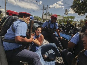 FILE - In this March 16, 2019 file photo, police detain protesters in Managua, Nicaragua. Nicaraguan government negotiators have signed an agreement on Friday, March 29, ratifying their commitment to free hundreds of people considered political prisoners by the opposition.