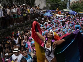 A reveler performs during the Carmelitas street party in Rio de Janeiro, Brazil, Friday, March 1, 2019. Much of the appeal of Rio street parties is the variety of themes and that people can dress up in costumes or not.