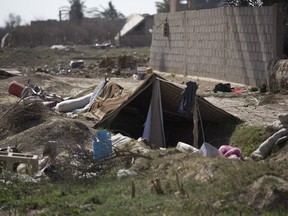 A tent is pitched over a trench left behind by Islamic State militants, in Baghouz, Syria, as U.-S.-backed Syrian Democratic forces continued their push to oust IS from their last territory, Monday, March 11, 2019.