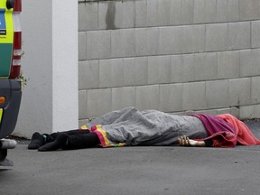 A body lies on the footpath outside a mosque in central Christchurch, New Zealand, Friday, March 15, 2019. A witness says many people have been killed in a mass shooting at a mosque in the New Zealand city of Christchurch.