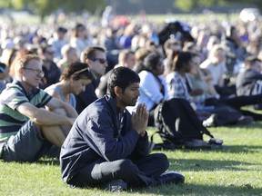 A man prays during a vigil in Hagley Park following the March 15 mass shooting in Christchurch, New Zealand, Sunday, March 24, 2019.