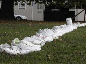 Fifty pairs of white shoes line up as a memorial to the victims of Friday March 15 mass mosque shootings in front of a church in Christchurch, New Zealand, Tuesday, March 19, 2019. Four days after Friday's attack, New Zealand's deadliest shooting in modern history, relatives were anxiously waiting for word on when they can bury their loved ones.
