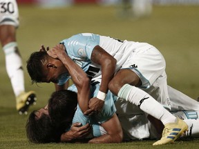 Racing Club's midfielder Augusto Solari celebrates with his teammates after scoring against Tigre during an Argentine Superliga soccer match in Victoria, on the outskirts of Buenos Aires, Argentina, Sunday, March 31, 2019.