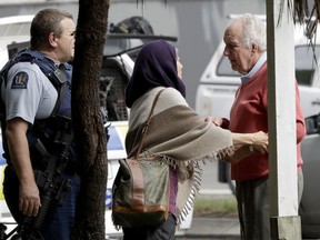 Police escort people away from outside a mosque in central Christchurch, New Zealand, Friday, March 15, 2019. Multiple people were killed in mass shootings at two mosques full of people attending Friday prayers, as New Zealand police warned people to stay indoors as they tried to determine if more than one gunman was involved.