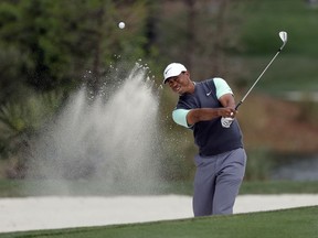 Tiger Woods blasts from a sand trap on the second hole during the third round of The Players Championship golf tournament Saturday, March 16, 2019, in Ponte Vedra Beach, Fla.