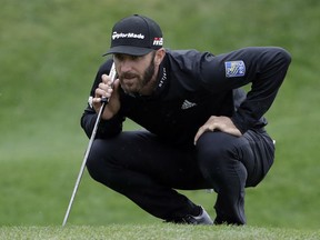 Dustin Johnson lines up a putt on the second hole during the final round of The Players Championship golf tournament Sunday, March 17, 2019, in Ponte Vedra Beach, Fla.