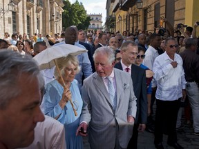 Britain's Prince Charles, the Prince of Wales, center, and his wife Camilla, Duchess of Cornwall, take a guided tour of the historical area of Havana, Cuba, Monday, March 25, 2019. The royal couple began the first official trip to Cuba by the British royal family on Sunday, in a pomp-filled display of disagreement with the Trump administration's strategy of economically isolating the communist island.