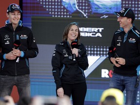 Williams driver Robert Kubica of Poland, right, and teammate George Russell of Britain, laugh with team principal Williams team principal Claire Williams during the launch for the Australian Grand Prix in Melbourne, Australia, Wednesday, March 13, 2019.