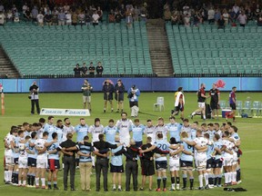 The Waratahs and the Crusaders Super Rugby teams join together before their game for a minute-long silence for the victims of the New Zeland mass shootings in Sydney, Australia, Saturday, March 23, 2019.