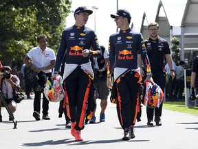 Red Bull driver Max Verstappen of the Netherlands, left, and teammate Pierre Gasly of France walk through the paddock ahead of the Australian Grand Prix in Melbourne, Australia, Thursday, March 14, 2019.