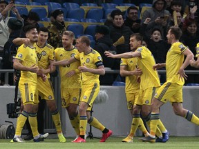 Kazakhstan's players celebrate after Kazakhstan's Yuriy Pertsukh, left, scored his side's opening goal during the Euro 2020 group I qualifying soccer match between Kazakhstan and the Scotland at Astana Arena stadium in Astana, Kazakhstan, Thursday, March 21, 2019.