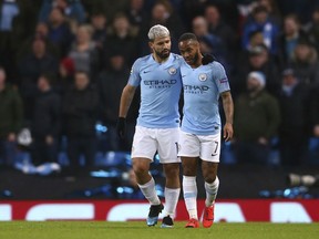 Manchester City's Sergio Aguero, left, celebrates with his teammate Manchester City's Raheem Sterling after scoring his side's second goal during the Champions League round of 16 second leg, soccer match between Manchester City and Schalke 04 at Etihad stadium in Manchester, England, Tuesday, March 12, 2019.