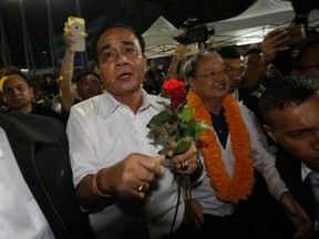 Thai Prime Minister Prayuth Chan-ocha of the Palang Pracharat Party receives flowers from supporters during an election campaign rally in Bangkok, Thailand, Friday, March 22, 2019. The political movement that has won every Thai election in nearly two decades is facing its biggest test yet: Squaring off against the allies of the military junta that removed it from power and rewrote the electoral rules with the goal of putting an end to those victories.