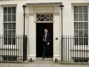 Chancellor of the Exchequer Philip Hammond leaves from Downing Street to go to Parliament to deliver his spring statement in London, Wednesday, March 13, 2019. European Union officials on Wednesday criticized the U.K. Parliament for rejecting a Brexit deal for a second time as the bloc prepared for a chaotic, cliff-edge departure.