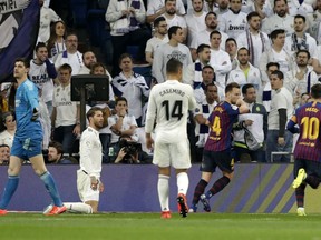 Barcelona midfielder Ivan Rakitic, second left, reacts after scoring the opening of his team during the Spanish La Liga soccer match between Real Madrid and FC Barcelona at the Bernabeu stadium in Madrid, Saturday, March 2, 2019.