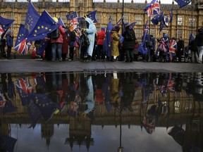 Anti-Brexit remain in the European Union supporters, take part in a protest outside the House of Parliament in London, Tuesday, March 12, 2019. Prime Minister Theresa May's mission to secure Britain's orderly exit from the European Union appeared headed for defeat Tuesday, as lawmakers ignored her entreaties to support her divorce deal and end the political chaos and economic uncertainty that Brexit has unleashed.