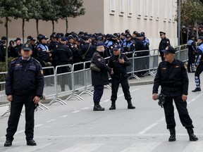 Policemen line up outside the Prime Minister's office ahead of an anti-government rally in Tirana, Albania on Saturday, March 16, 2019. The center-right opposition Democratic party demands the government's resignation, accusing the Cabinet of corruption and opposition lawmakers have relinquished their seats in parliament and they have rejected calls for dialogue from Socialist Prime Minister Edi Rama and from the U.S. and European Union.